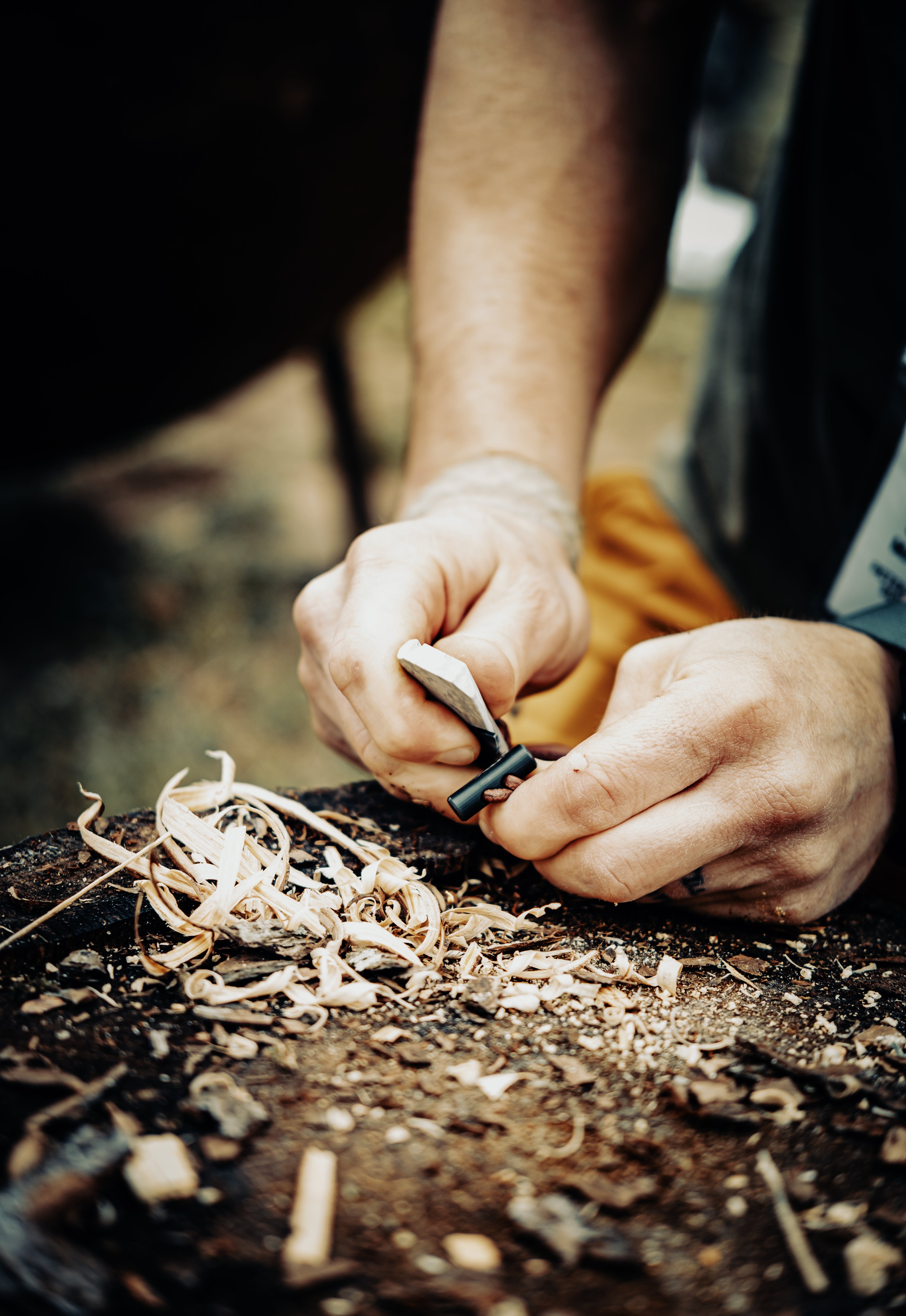 Person starting a fire on a rustic surface