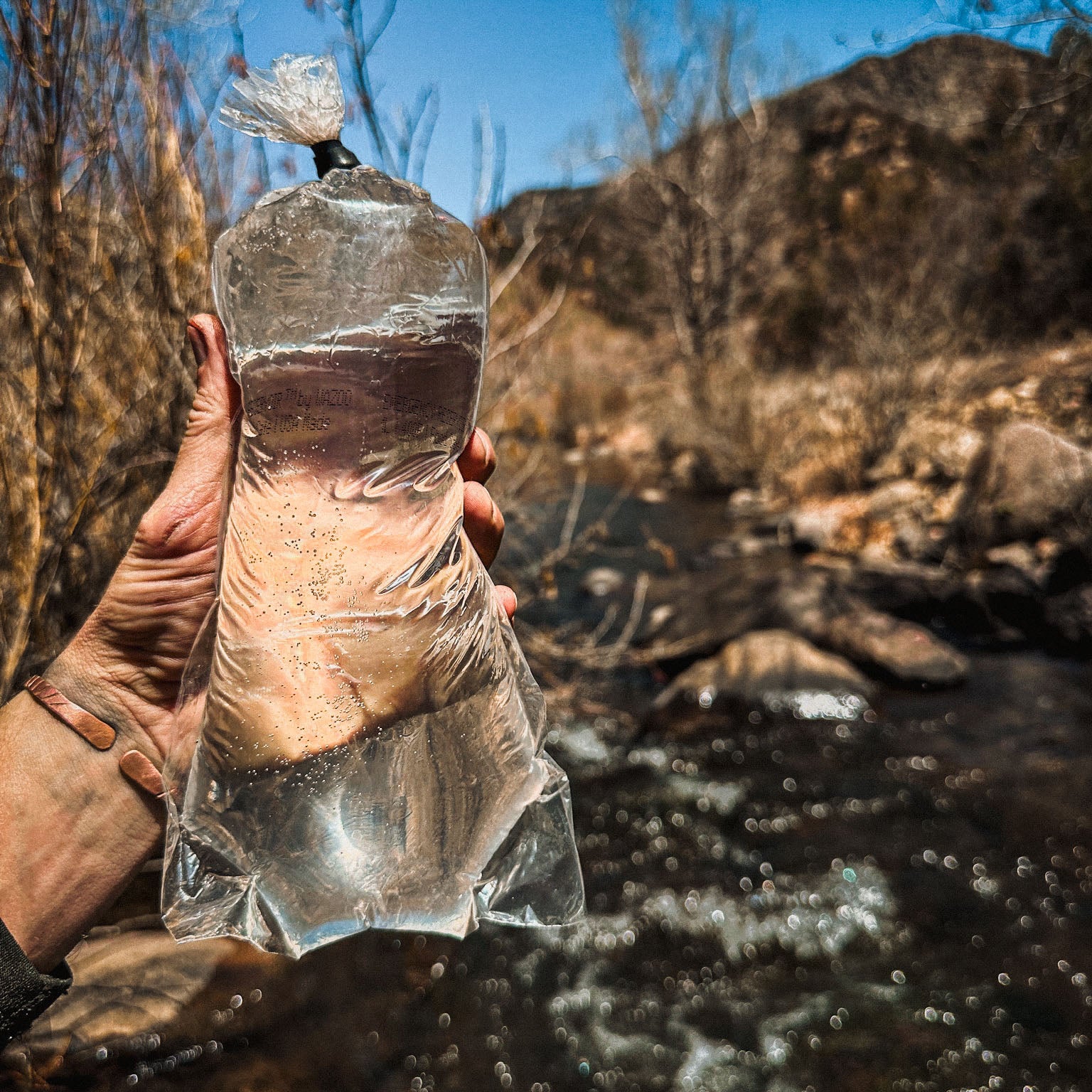Hand holding Water Bag filled with water