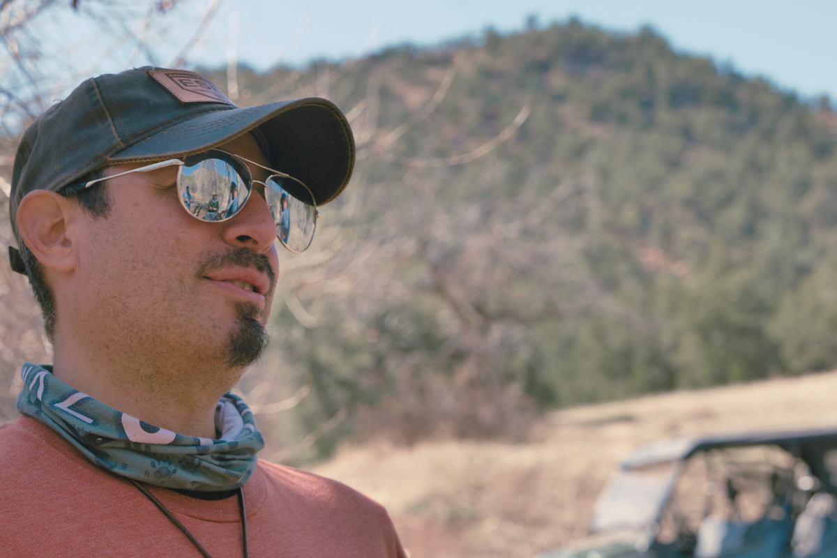 Reuben Bolieu demonstrating ultralight backpacking gear and shelter setup outdoors