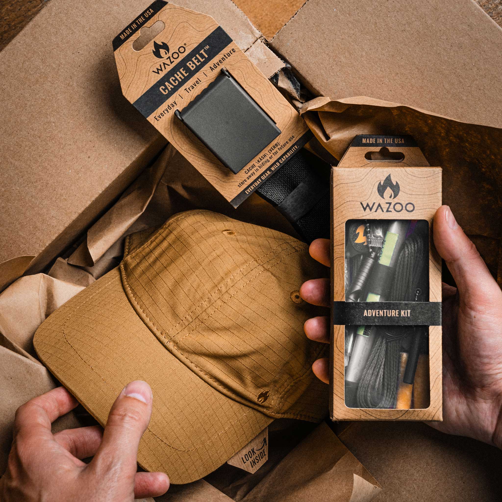 Wazoo Cache Belt and Adventure Kit packaging with a tan cap on a brown paper background