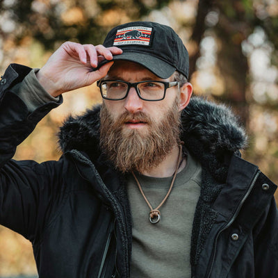 Man wearing a black cap in a black parka outdoors