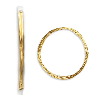 Gold wire in a spool and a coil on a white background