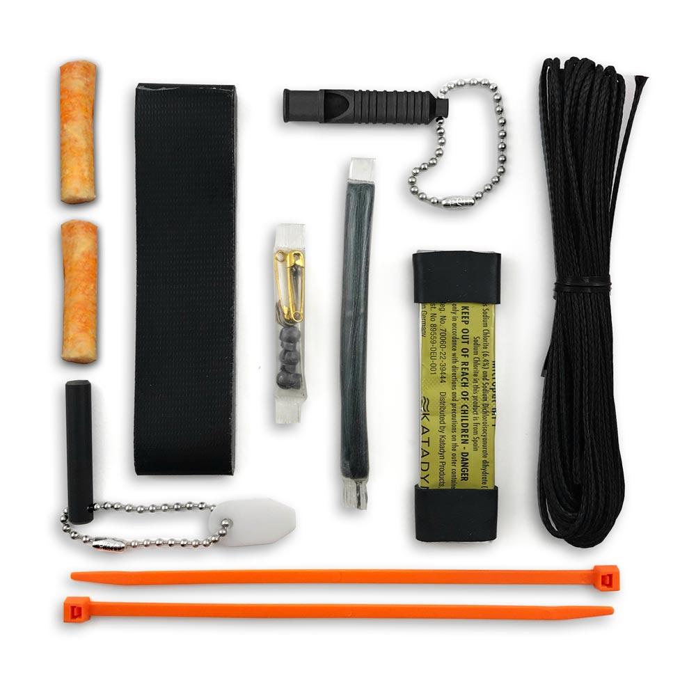 15 tool survival kit laid flat with whistle tinder plugs ferro rod scraper and coradage