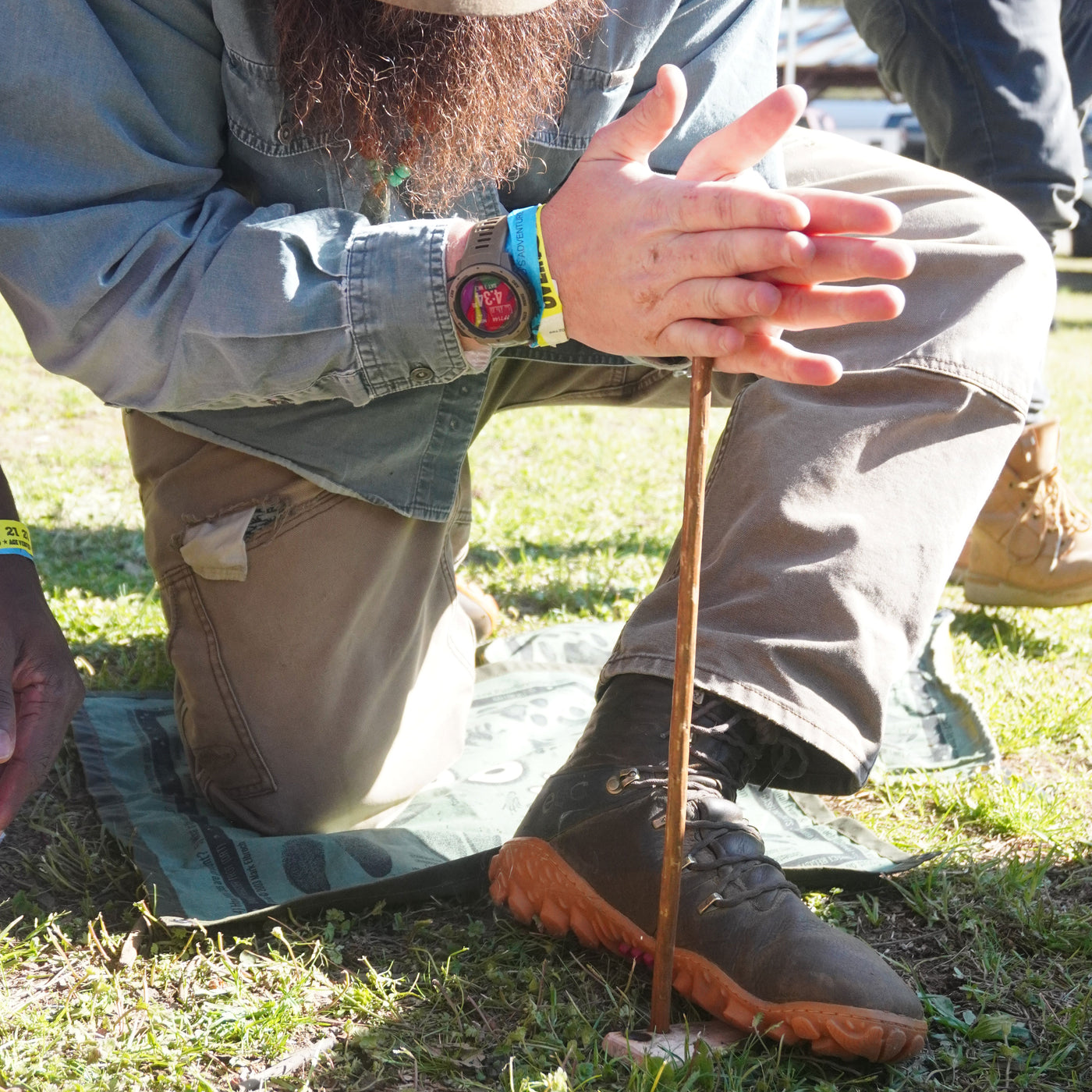 Wazoo groundcloth used as kneeling pad while making a hand drill fire