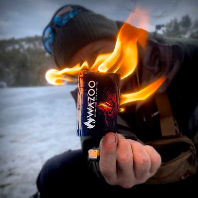 Firecard held in hand burning in cold snowy environment