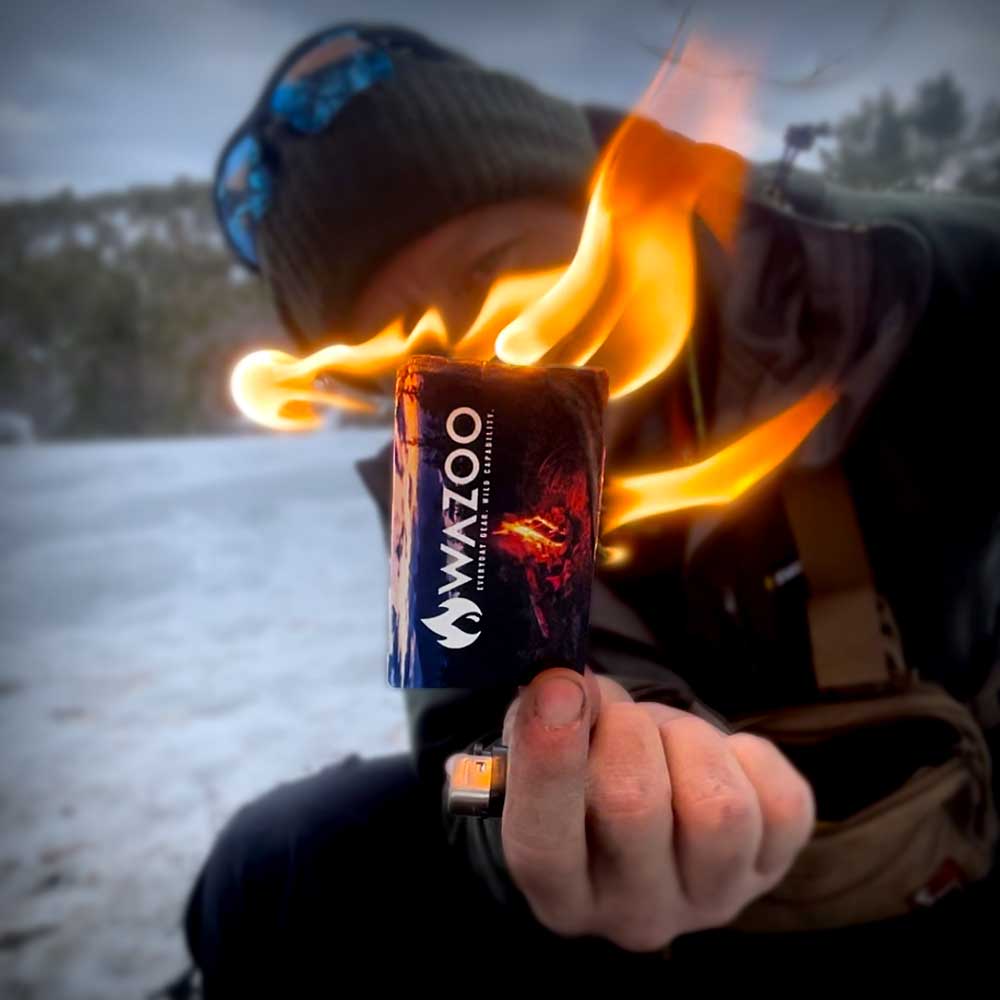 Firecard held in hand burning in cold snowy environment