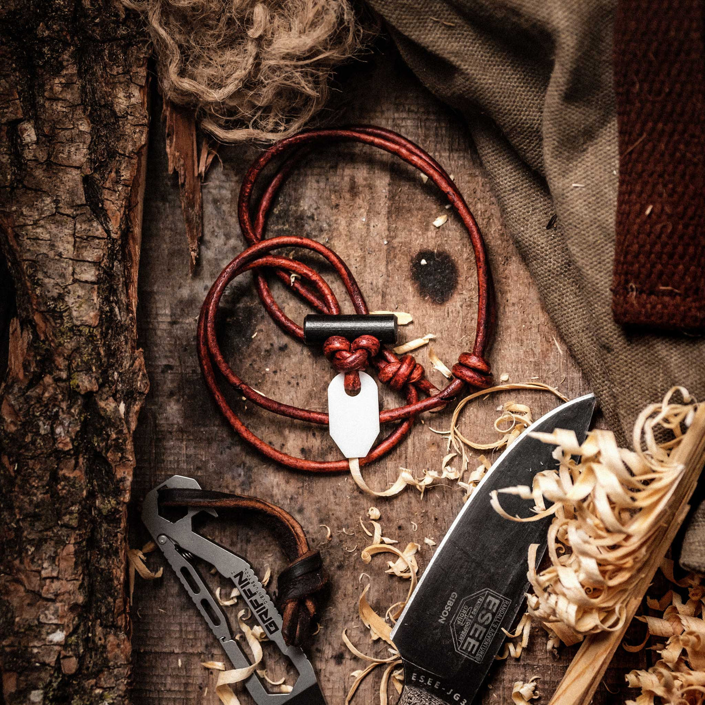 Wazoo Bushcraft Necklace shown with griffin adventure pocket tool and ESEE JG3 knife