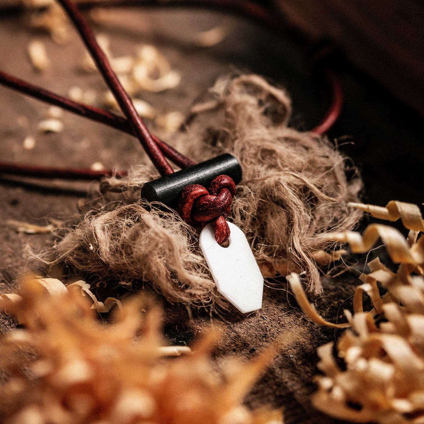Many tinder sources with the Wazoo Bushcraft Necklace for fire starting with white ceramic